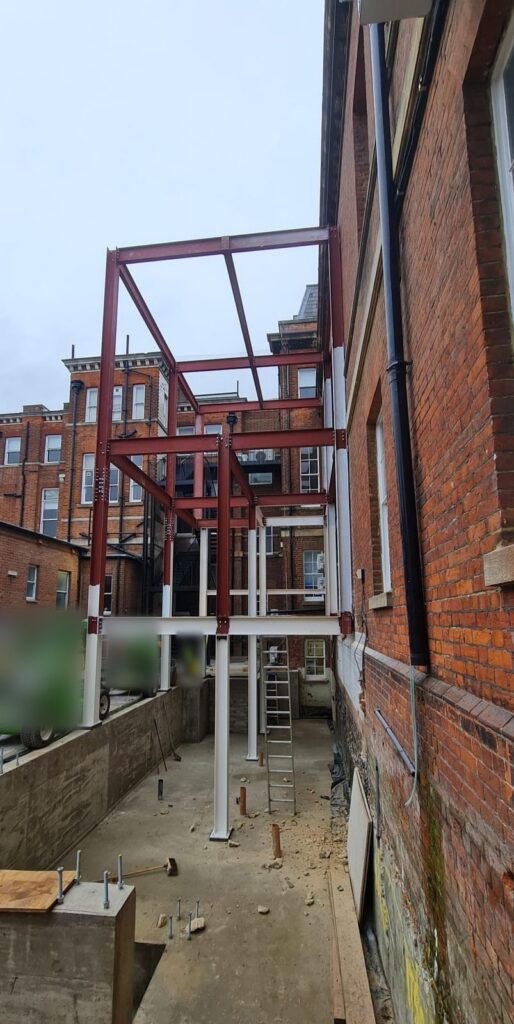 The frame rising against the hospital building