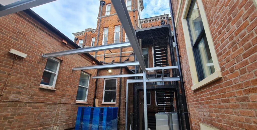 Plant enclosure frame against the existing building